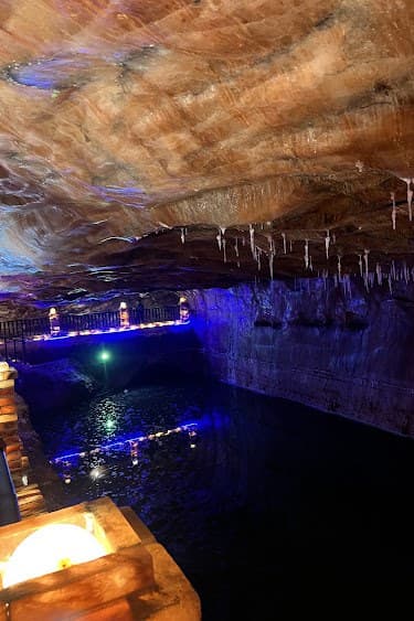 Illuminated brine pond chamber inside Khewra Salt Mine